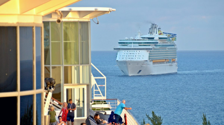 Royal-Caribbean-cruise-ship-in-water-with-Celebrity-ship-deck-in-forefront.jpg