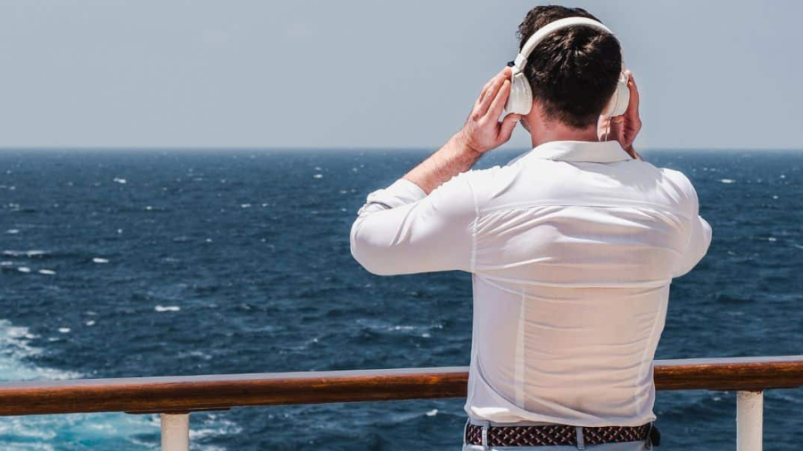man-listening-to-music-on-a-cruise-ship-deck.jpg