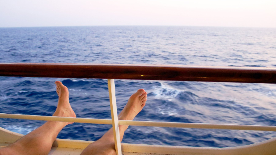 Man-on-cruise-ship-balcony-relaxing.jpg