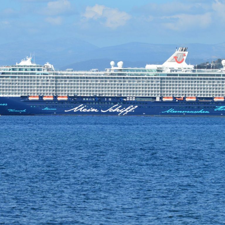 A large cruise ship sailing across open ocean waters